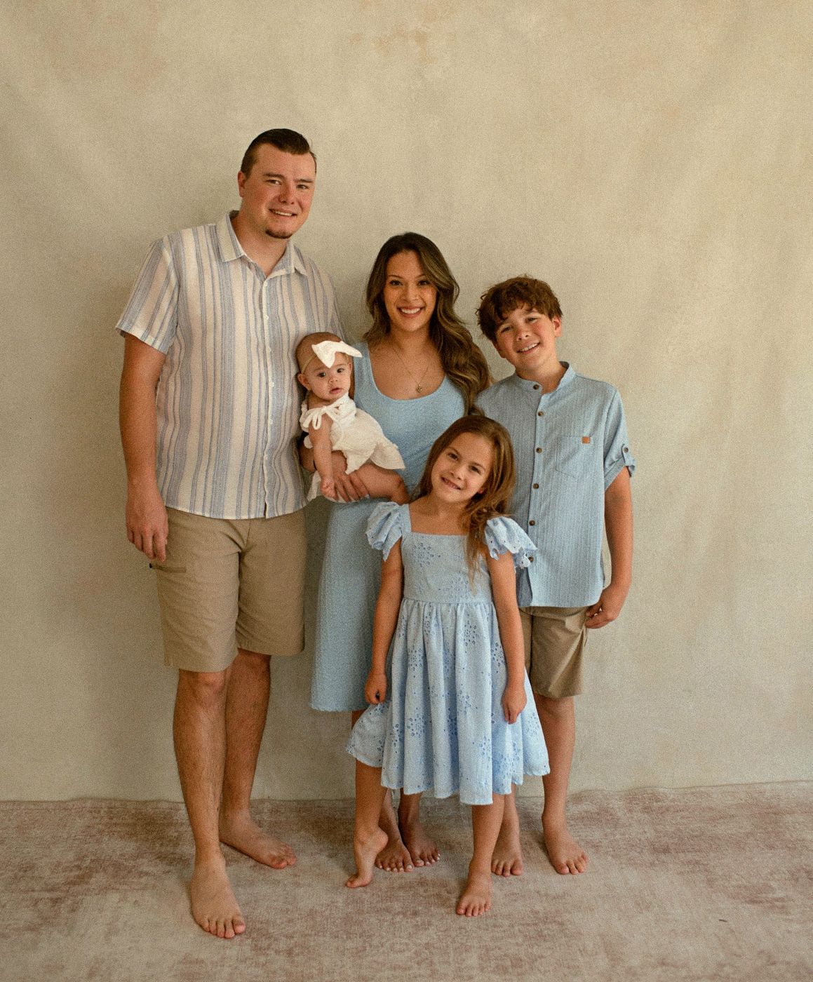 The Phelps family portrait, all five smiling at the camera